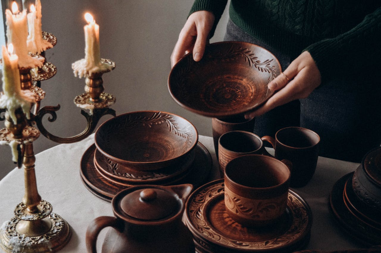Warm-toned pottery and candlesticks create a cozy, traditional table setting ambiance.